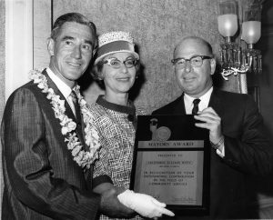 Mr. and Mrs. Brechner (center and right) accept the National Mayors Conference and Broadcast Pioneers Award for best local community service by a television station, New York, 1964.
